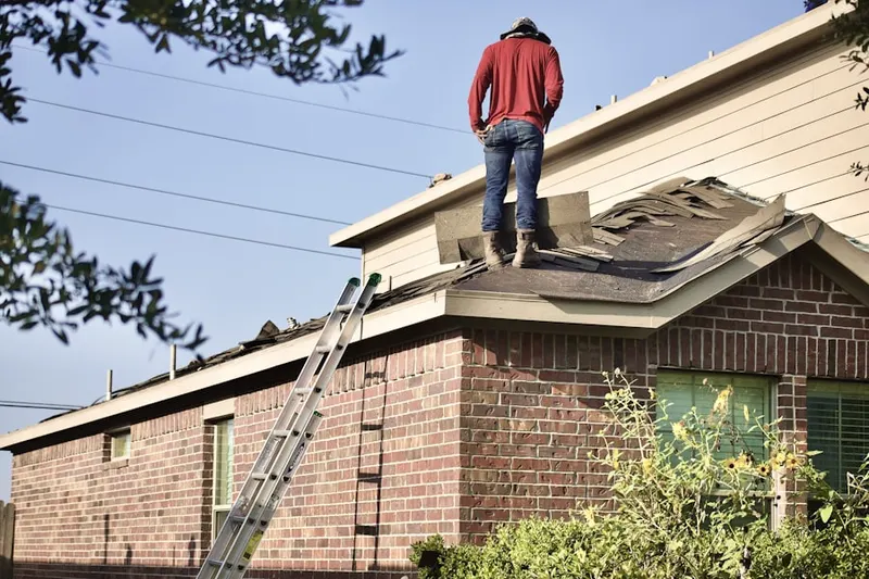 Professional roofer working on a residential roof in Stone Mountain